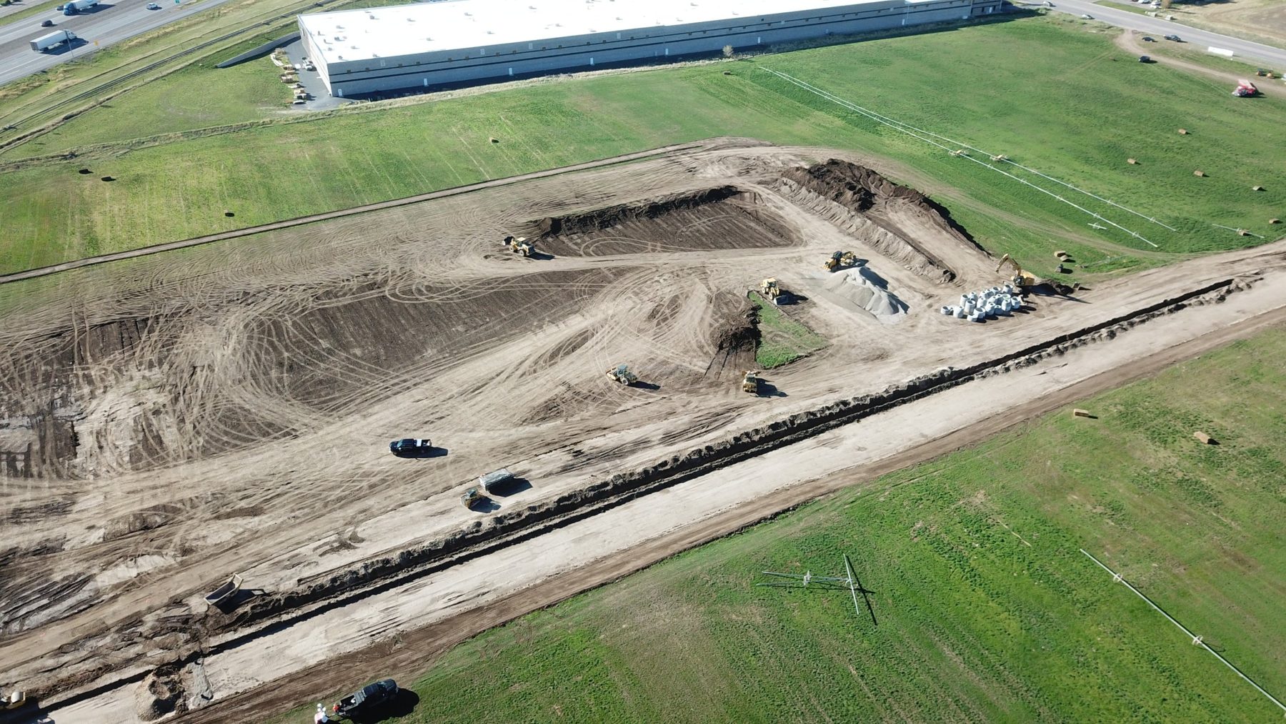 Aerial view of site grading and utility trenching at Payson Central beside the I-15 corridor